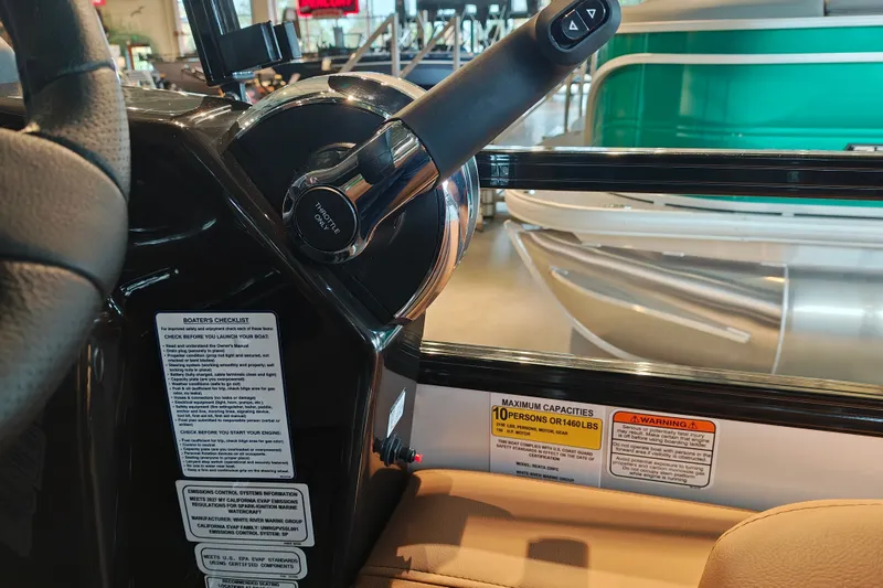 Slide: The Image of Throttle control and safety labels on 2027 Ranger 220FC boat dashboard. - 31
