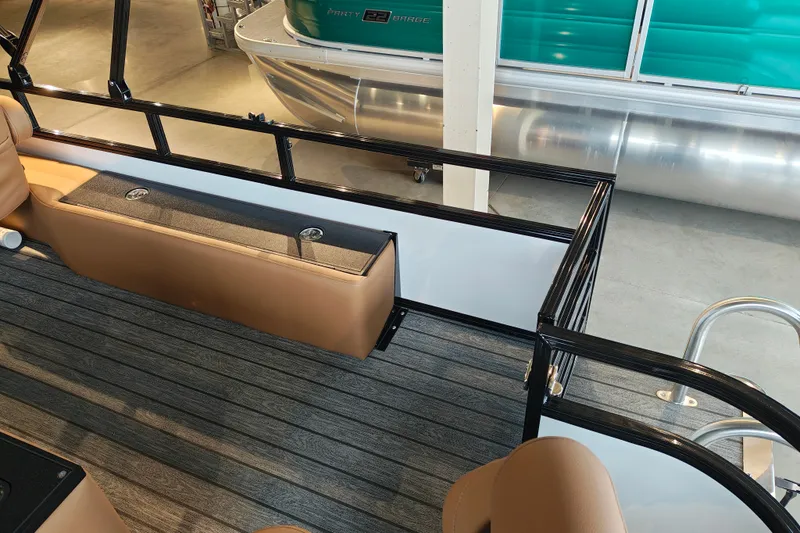 Slide: The Image of Interior view of a 2027 Ranger 220FC boat with tan seating and sleek design. - 51