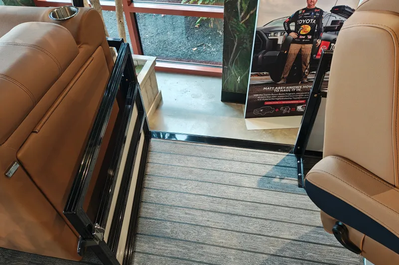 Slide: The Image of Interior of a 2027 Ranger 220FC with tan seats and promotional poster. - 38