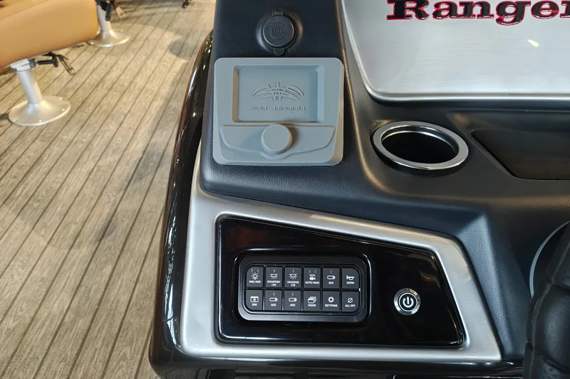 Slide: The Image of Control panel of 2027 Ranger 220FC boat with cup holder and electronic interface. - 26