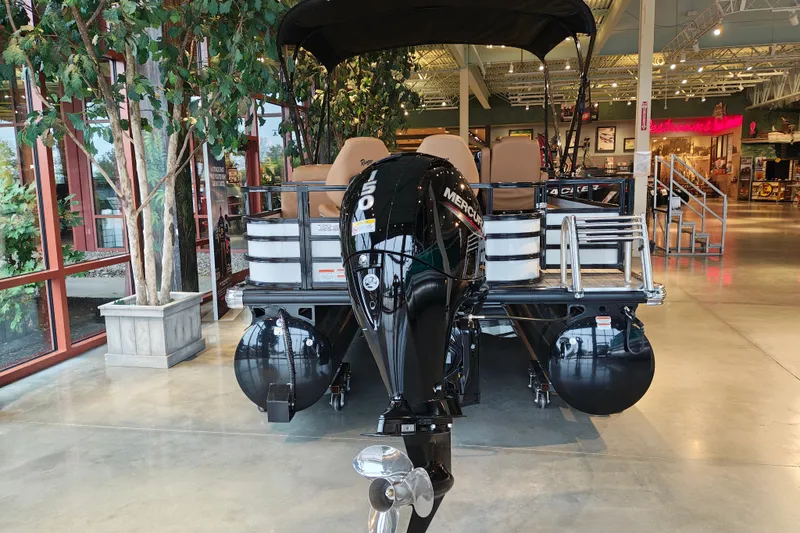 Slide: The Image of 2027 Ranger 220FC boat with Mercury outboard motor displayed indoors. - 6