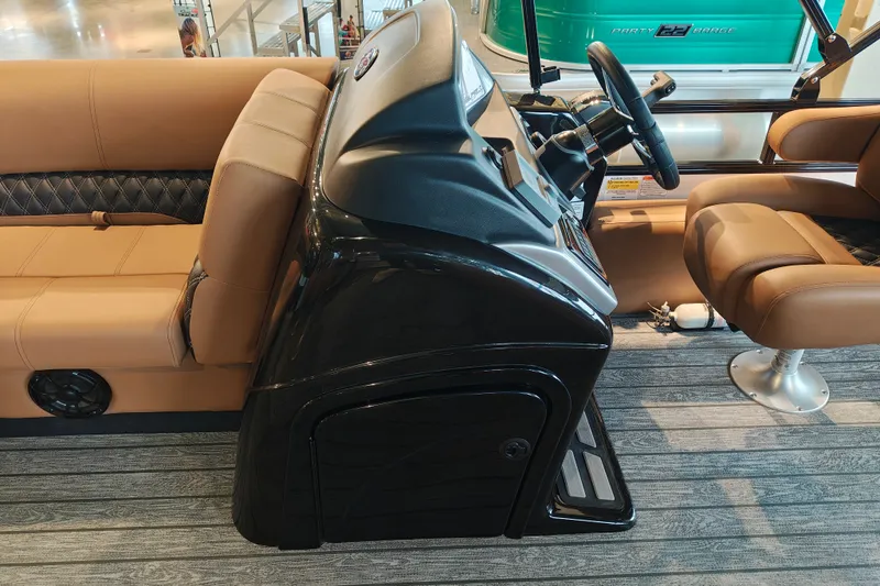 Slide: The Image of Interior of a 2027 Ranger 220FC boat with tan seating and steering console. - 18
