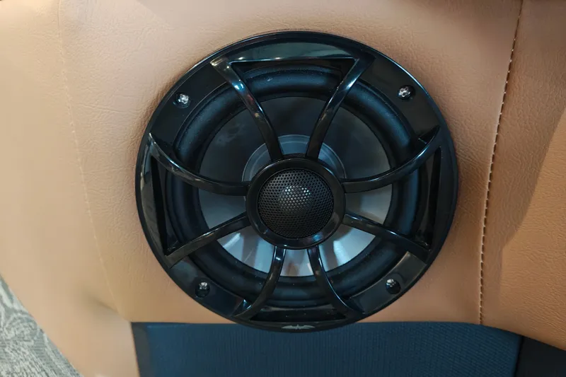 Slide: The Image of Speaker installed in a 2027 Ranger 220FC, set against tan upholstery. - 62