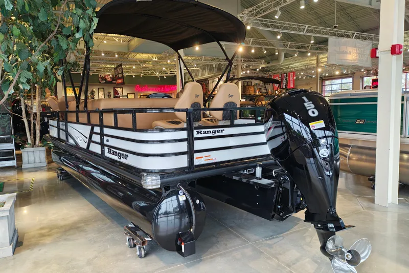 Slide: The Image of 2027 Ranger 220FC pontoon boat with canopy and powerful outboard motor in showroom. - 7