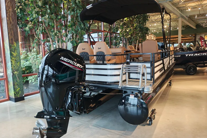 Slide: The Image of 2027 Ranger 220FC pontoon boat with Mercury outboard motor in showroom setting. - 5