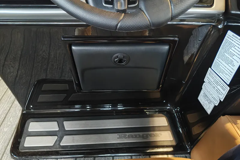 Slide: The Image of 2027 Ranger 220FC dashboard with steering wheel and storage compartment. - 29