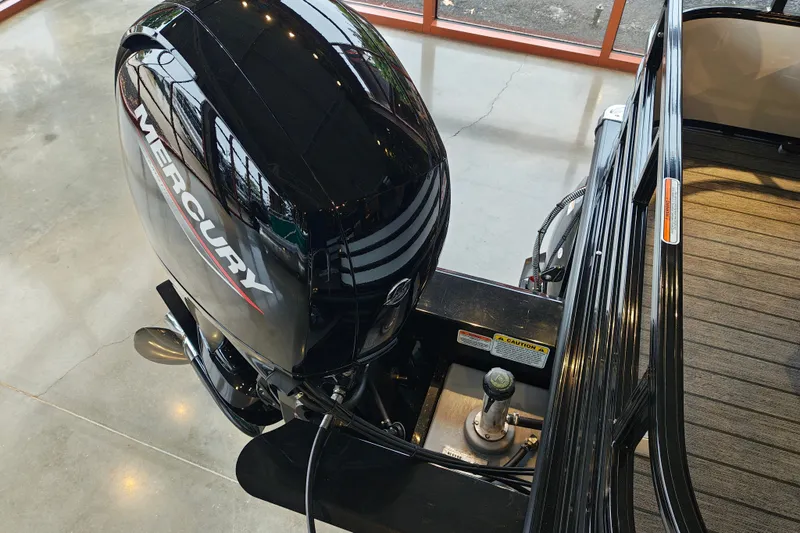 Slide: The Image of Ranger 220FC 2027 boat with Mercury outboard motor in showroom. - 56