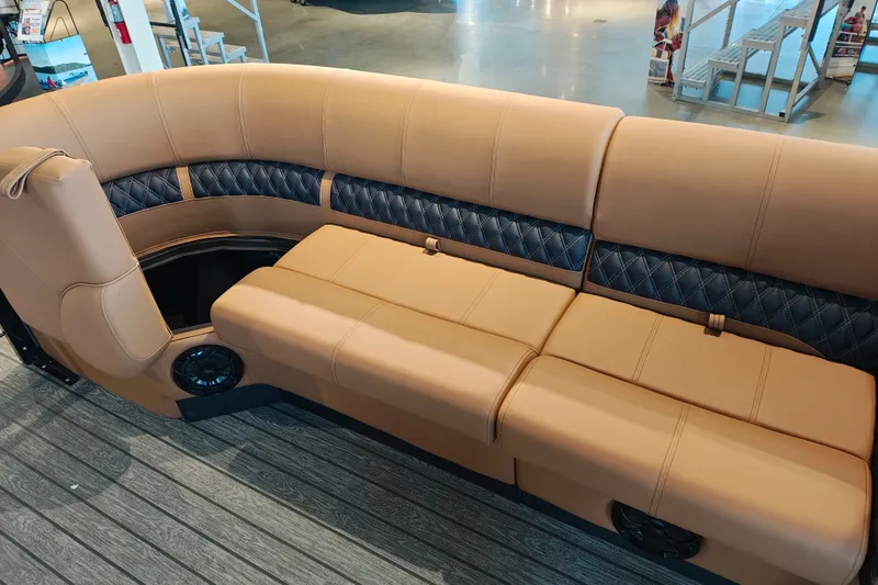 Slide: The Image of Luxurious seating on 2027 Ranger 220FC boat, featuring tan and black upholstery with integrated speakers. - 11