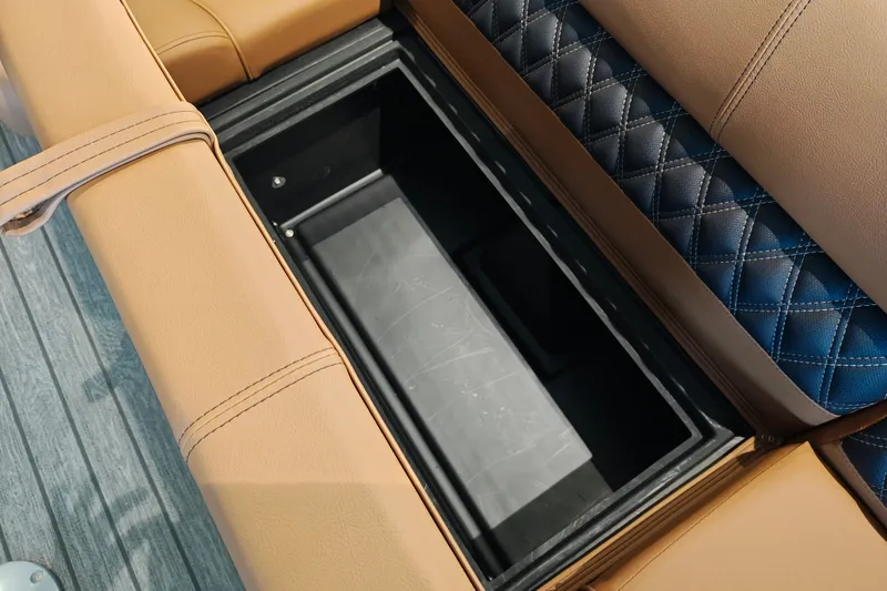 Slide: The Image of Ranger 220FC 2027 boat seat storage compartment with tan and blue upholstery. - 14