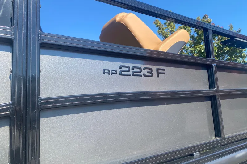 Slide: The Image of Close-up of 2027 Ranger 223F boat railing with logo under clear blue sky. - 3