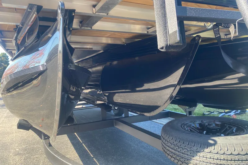 Slide: The Image of Underneath view of a 2027 Ranger 223F boat on a trailer, showcasing its sleek black hull. - 4