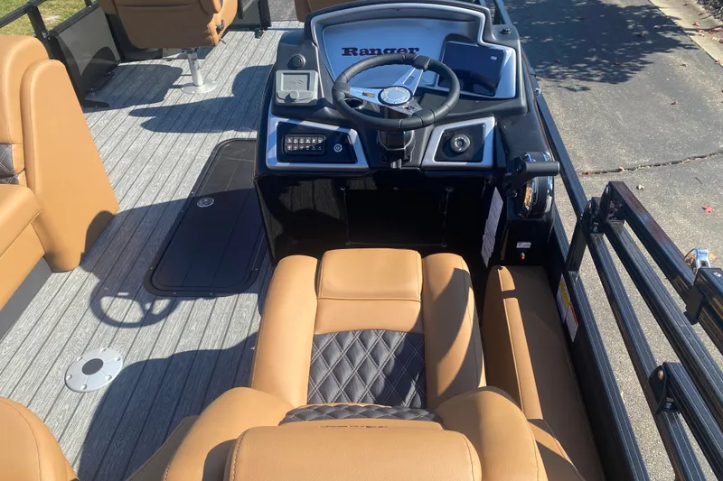 Slide: The Image of Interior of 2027 Ranger 223F boat with tan seating and steering console. - 7