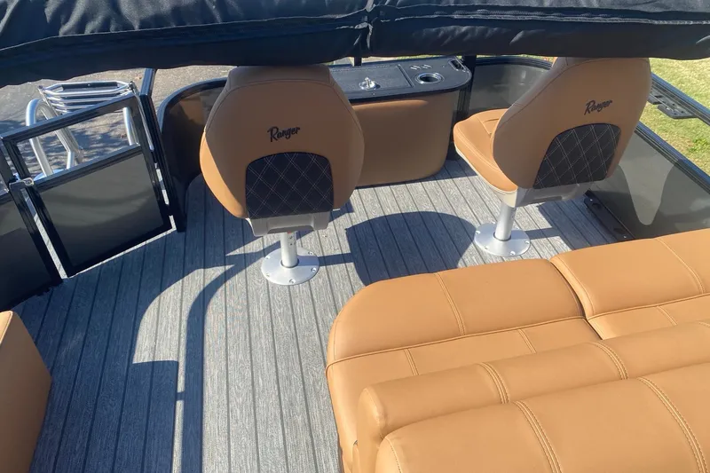 Slide: The Image of Interior of 2027 Ranger 223F boat with tan seating and modern design. - 12