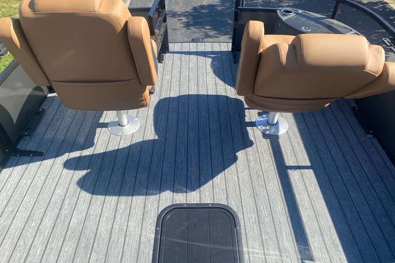 Slide: The Image of Two tan seats on a 2027 Ranger 223F boat with gray flooring. - 8