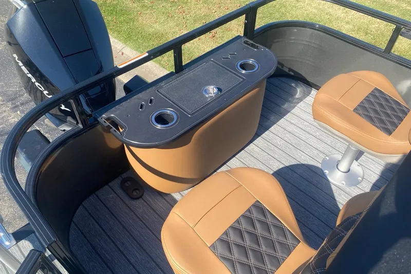 Slide: The Image of 2027 Ranger 223F boat interior with tan seats and a black console. - 15