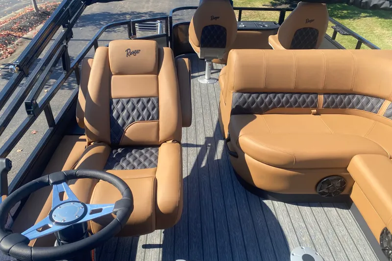 Slide: The Image of 2027 Ranger 223F boat interior with tan leather seating and modern steering wheel. - 11