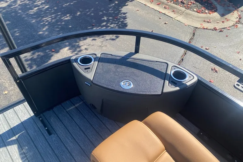 Slide: The Image of 2027 Ranger 223F boat deck with seating and cup holders, under sunny skies. - 10