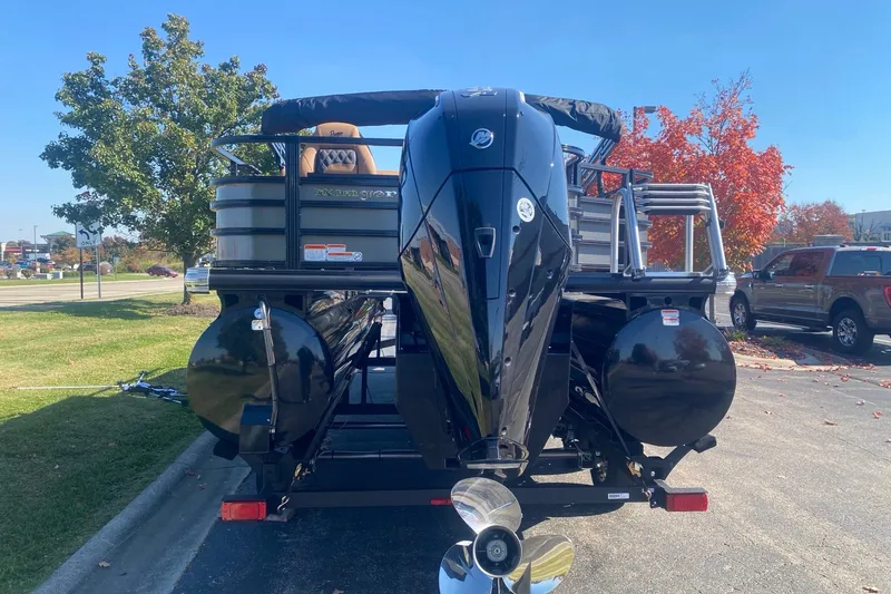Slide: The Image of 2027 Ranger 223F pontoon boat with powerful outboard motor, parked outdoors. - 16