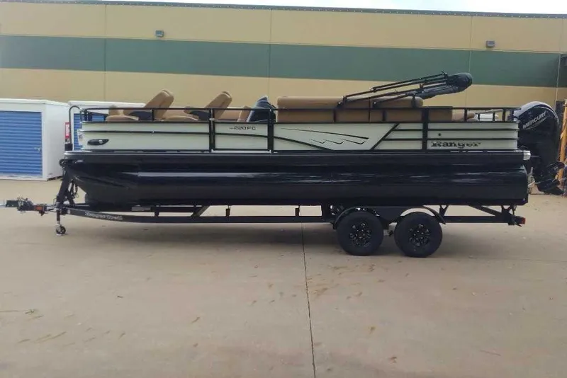 Slide: The Image of 2027 Ranger 220FC pontoon boat on trailer, parked outdoors. - 7