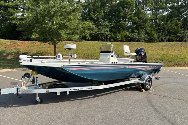 Slide: The Image of 2027 Ranger RB190 boat on trailer in parking lot, surrounded by trees. - 4