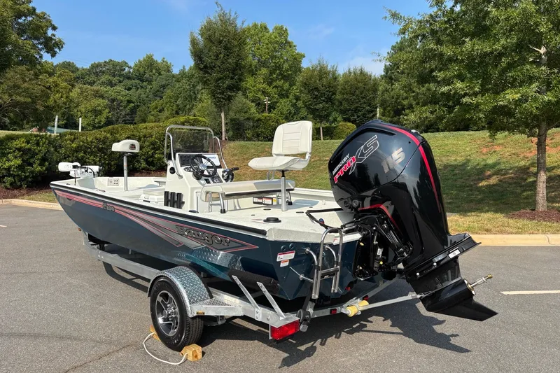 Slide: The Image of 2027 Ranger RB190 boat with powerful outboard motor on a trailer, parked outdoors. - 7