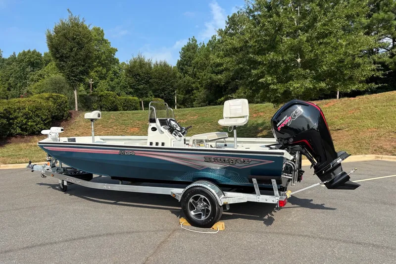 Slide: The Image of 2027 Ranger RB190 boat on trailer, parked outdoors with trees in background. - 6