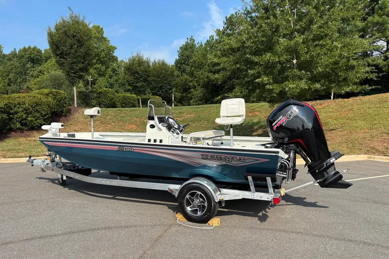 Slide: The Image of 2027 Ranger RB190 boat on trailer, parked outdoors with trees in background. - 5