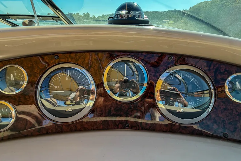 Slide: The Image of Dashboard of a 2003 Sea Ray 410 Sundancer boat with gauges and compass. - 22