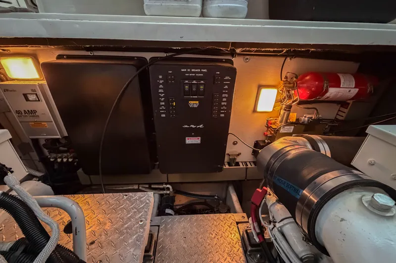 Slide: The Image of Engine room of 2003 Sea Ray 410 Sundancer with control panel and fire extinguisher. - 45