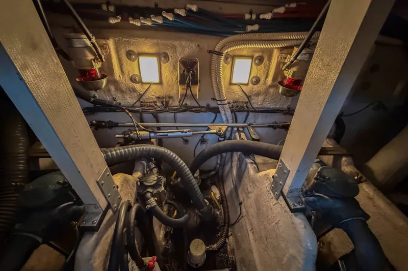 Slide: The Image of Engine room of a 2003 Sea Ray 410 Sundancer, showcasing mechanical components and wiring. - 46