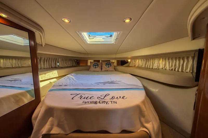 Slide: The Image of Luxurious cabin interior of 2003 Sea Ray 410 Sundancer yacht, featuring a cozy bed. - 31