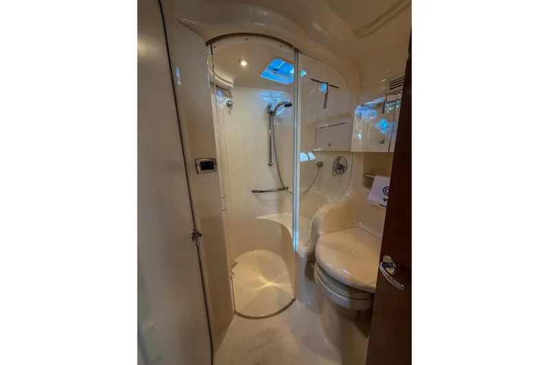 Slide: The Image of Bathroom interior of 2003 Sea Ray 410 Sundancer yacht, featuring shower and toilet. - 32