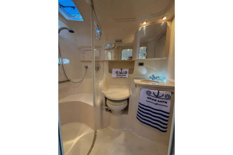 Slide: The Image of Luxurious bathroom in 2003 Sea Ray 410 Sundancer yacht, featuring elegant fixtures and nautical decor. - 33