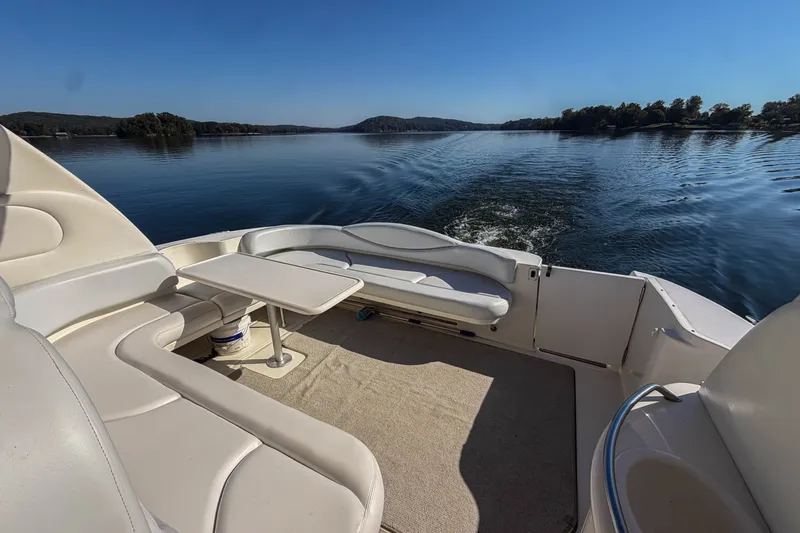 Slide: The Image of Luxurious 2003 Sea Ray 410 Sundancer yacht cruising on a serene lake with plush seating. - 19