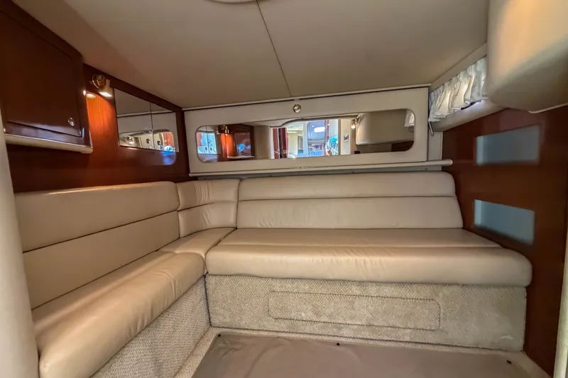Slide: The Image of Interior of 2003 Sea Ray 410 Sundancer yacht with beige seating and wooden accents. - 40