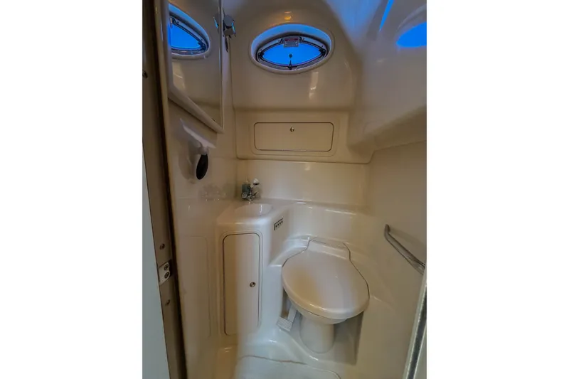 Slide: The Image of Compact bathroom in 2003 Sea Ray 410 Sundancer yacht with toilet and sink. - 39