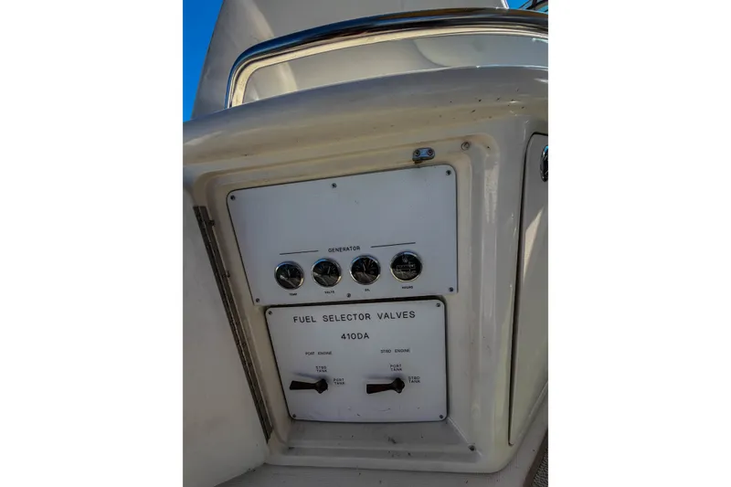 Slide: The Image of Control panel of a 2003 Sea Ray 410 Sundancer boat, featuring fuel selector valves. - 41