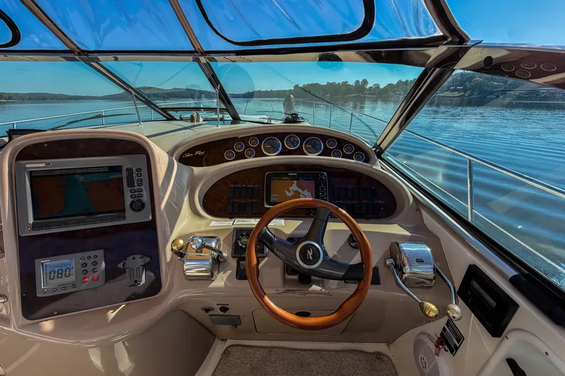 Slide: The Image of Cockpit view of 2003 Sea Ray 410 Sundancer yacht with navigation equipment and steering wheel. - 21