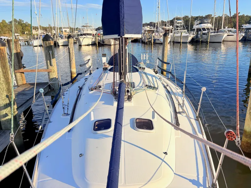 Slide: The Image of 2007 Beneteau First 36.7 docked, surrounded by other boats in a marina. - 27