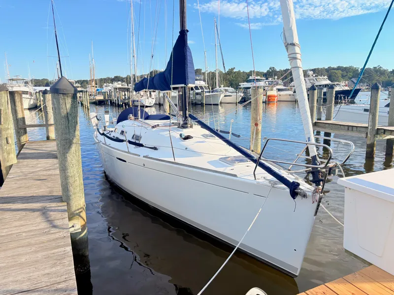The Image of A 2007 Beneteau First 36.7 docked at a wooden pier in a marina. - 0