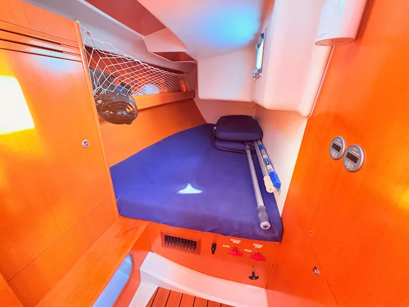 Slide: The Image of Cabin of the 2007 Beneteau First 36.7 with blue mattress and wooden interior. - 12