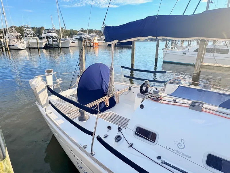 Slide: The Image of A 2007 Beneteau First 36.7 docked in a marina, featuring a blue sail cover and spacious cockpit. - 4
