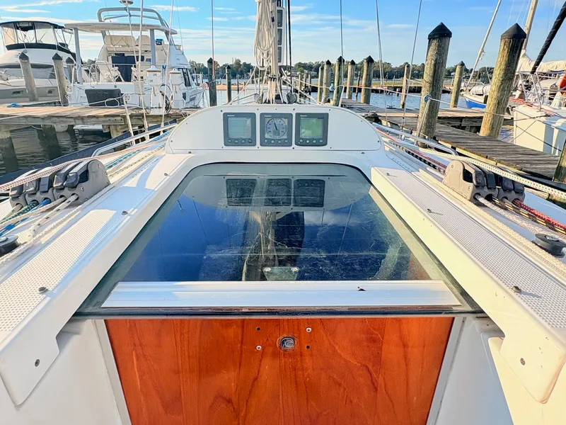 Slide: The Image of The image shows the cockpit of a 2007 Beneteau First 36.7 docked at a marina. - 10