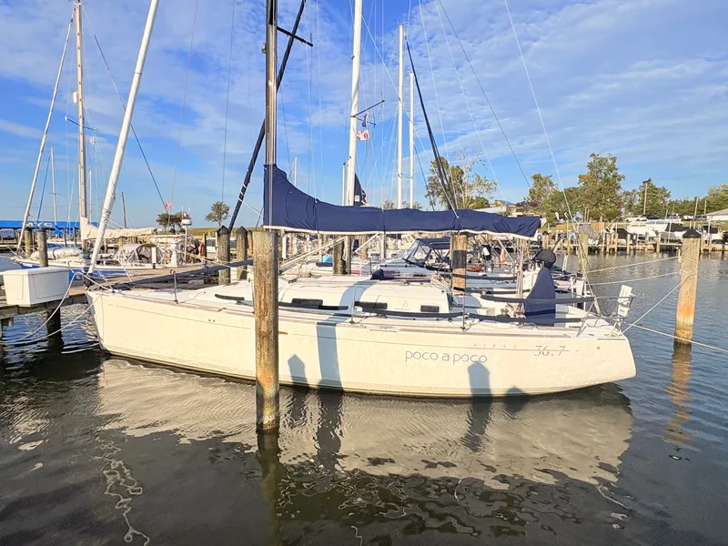 Slide: The Image of A 2007 Beneteau First 36.7 docked in the water, surrounded by other boats. - 3