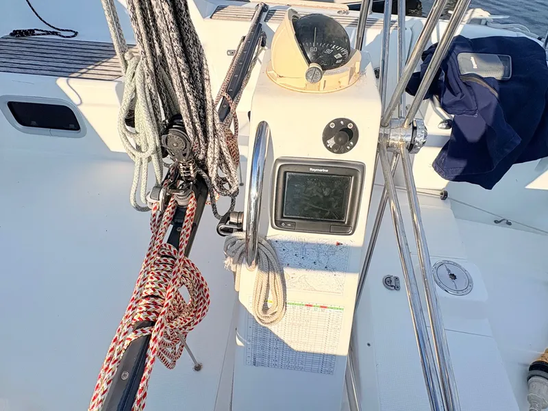 Slide: The Image of The cockpit of a 2007 Beneteau First 36.7 with a steering wheel and navigation instruments. - 6