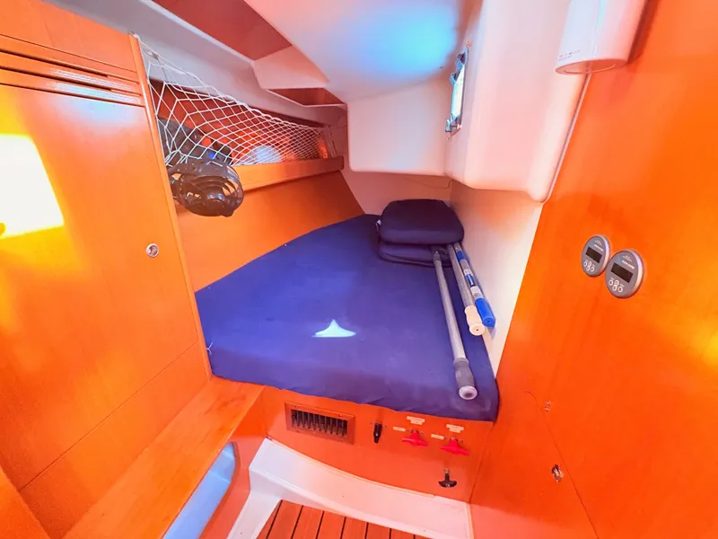 Slide: The Image of Cabin of the 2007 Beneteau First 36.7 with blue mattress and wooden features. - 13