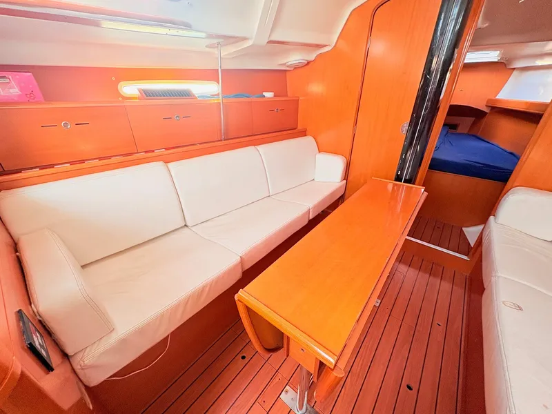 Slide: The Image of Interior of a 2007 Beneteau First 36.7 with wood flooring and white upholstery. - 19