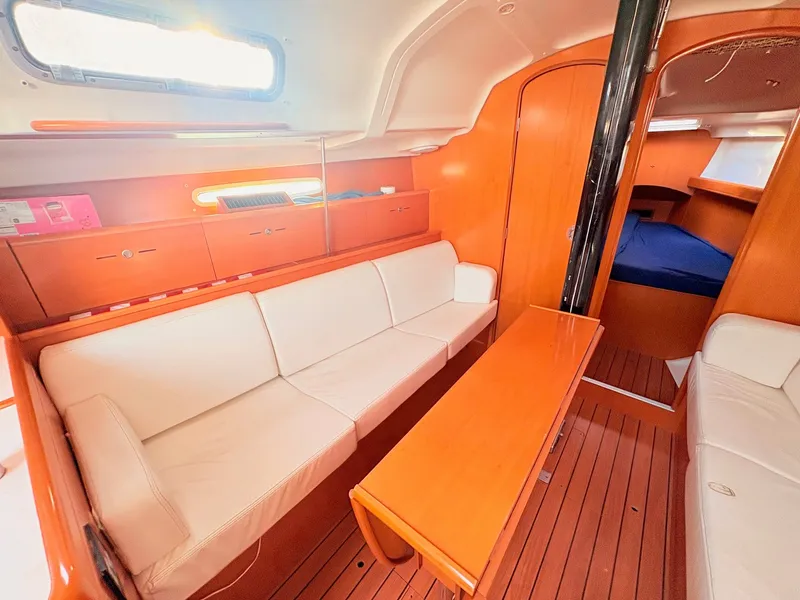 Slide: The Image of Interior of the 2007 Beneteau First 36.7 with wood floors and white sofas. - 18