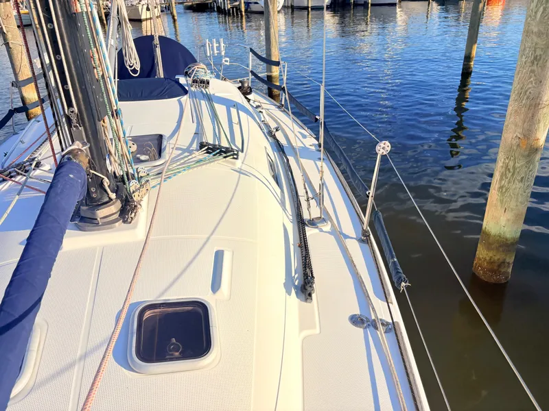 Slide: The Image of The deck of a 2007 Beneteau First 36.7 in a marina, featuring ropes and masts. - 28