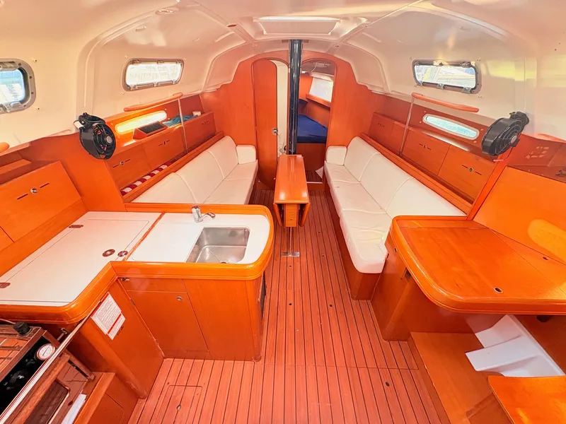 Slide: The Image of Interior of the 2007 Beneteau First 36.7 with wood floors and white upholstery. - 11